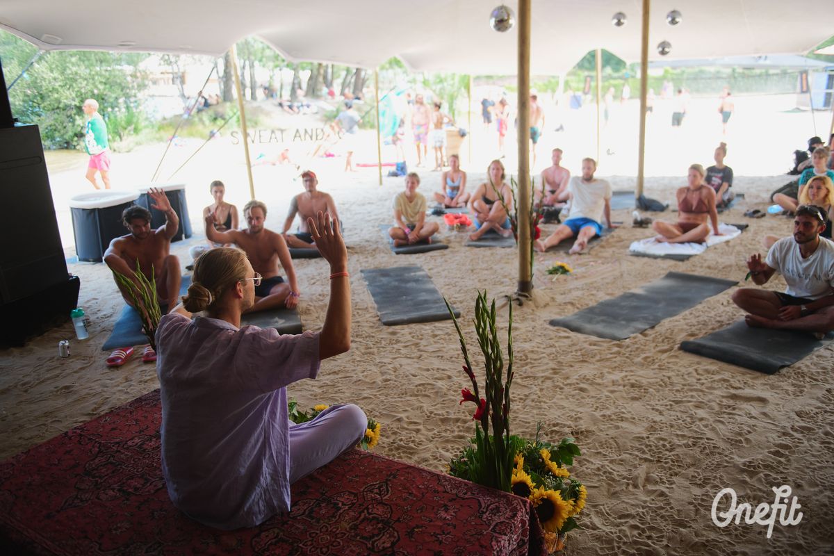 Large breathwork session under a festival tent at Awakenings 2022