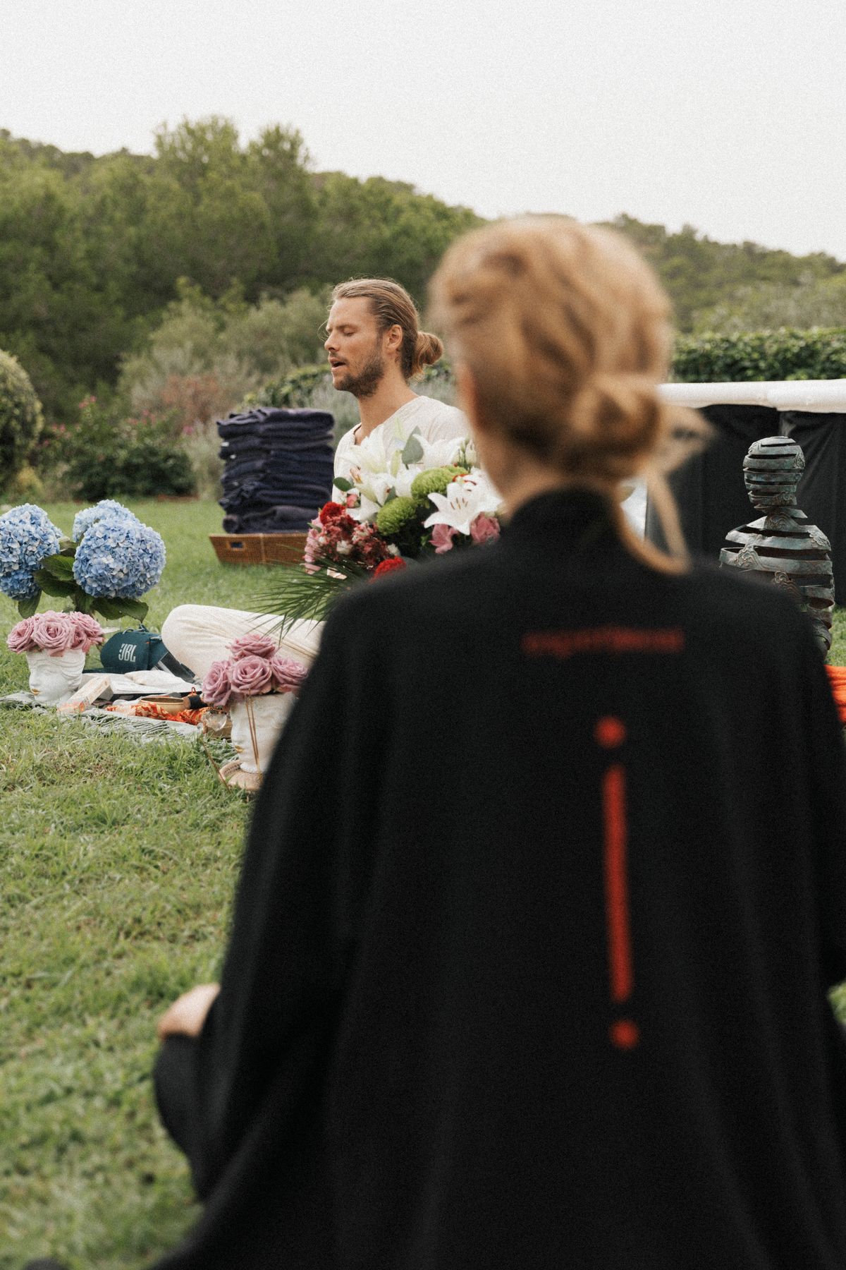 David explaining breathing methods to a group in an Ibiza garden, Experiment Retreat 2024