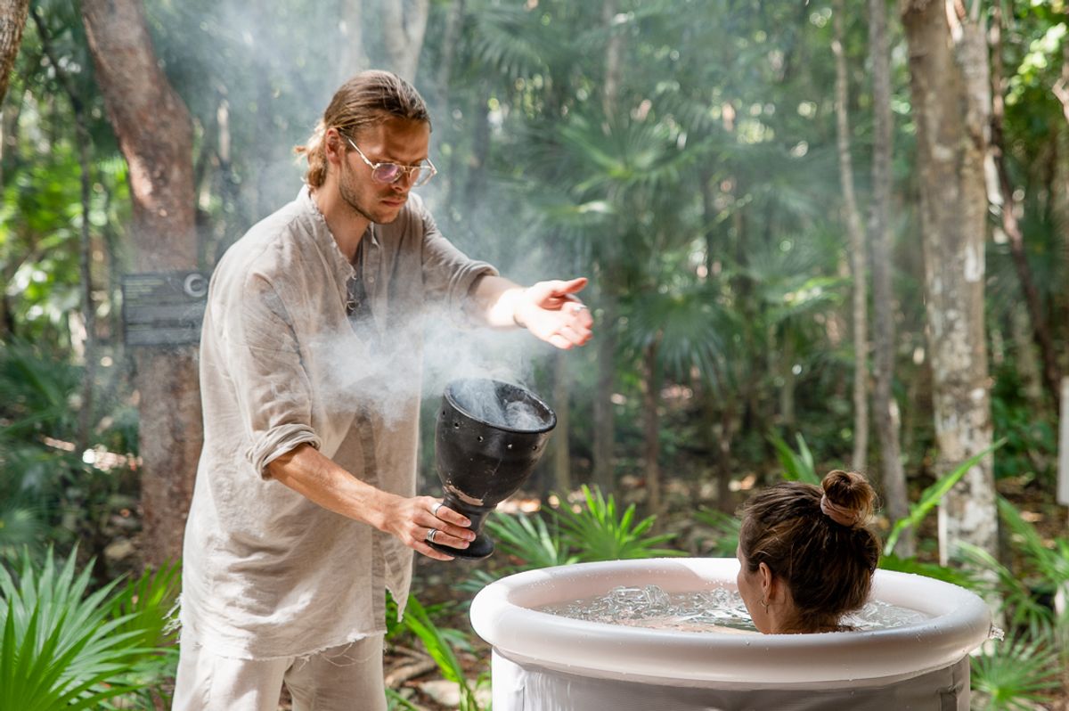 David holding copal incense with client in cold plunge, Tulum 2023